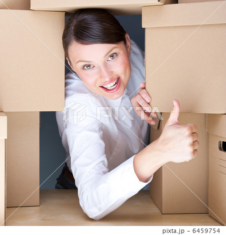 Portrait of young woman surrounded by lots of boxes. Lots of wor 6459754