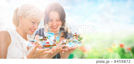 Portrait of two happy women mother and daughter looking their ph Portrait of two happy women mother and daughter looking their ph 6459872