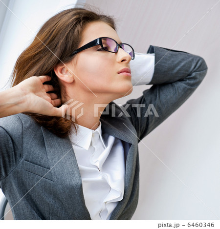 Happy business woman in the office resting and daydreaming Happy business woman in the office resting and daydreaming 6460346