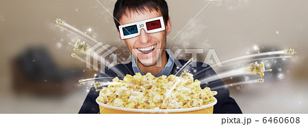 Portrait of young stylish modern man wearing 3d glasses watching 6460608