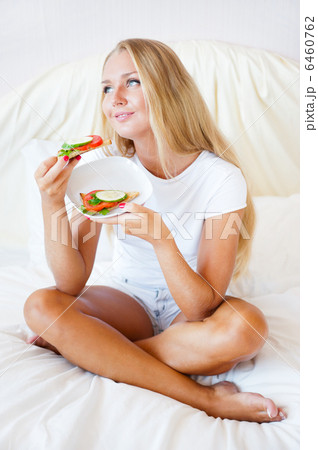 Woman having breakfast in bed. Healthy continental breakfast. Ca 6460762