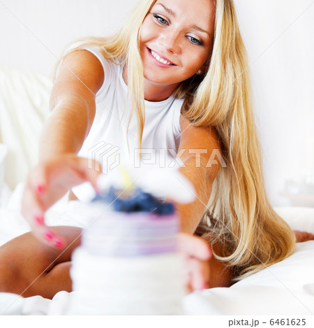 Boyfriend making a gift to his girlfriend in the morning. She is Boyfriend making a gift to his girlfriend in the morning. She is 6461625