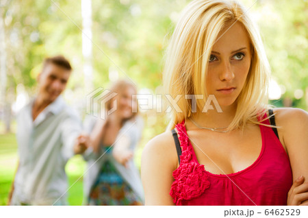 Upset teenage girl being jeered by group of the other young peop Upset teenage girl being jeered by group of the other young peop 6462529