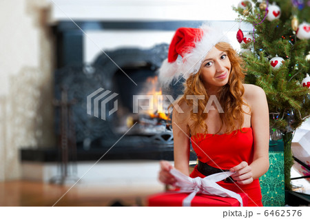 Christmas woman near a Christmas tree holding big gift box while 6462576