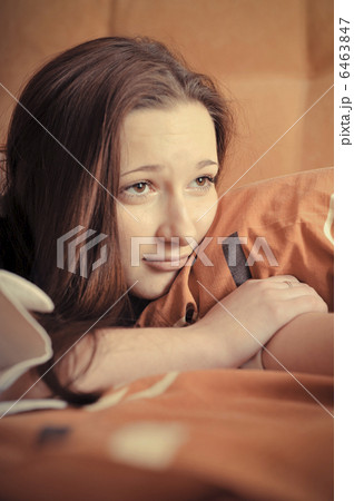Closeup portrait of young pretty girl laying on her bed Closeup portrait of young pretty girl laying on her bed 6463847