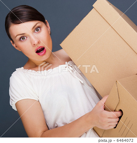 Closeup portrait of a young woman with boxes Closeup portrait of a young woman with boxes 6464072