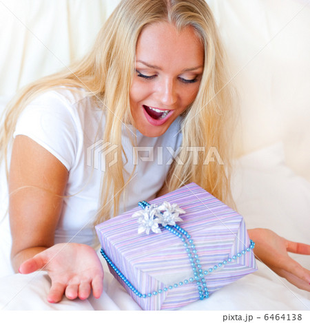 Bedroom surprise present - young happy woman in bedroom Bedroom surprise present - young happy woman in bedroom 6464138