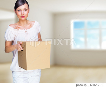 Smiling woman at her home holding boxes. She is Moving at her ne 6464208