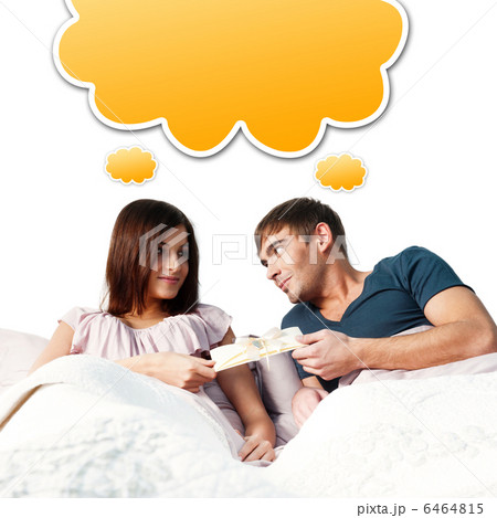 Closeup portrait of a happy young couple relaxing on the bed. Ma 6464815