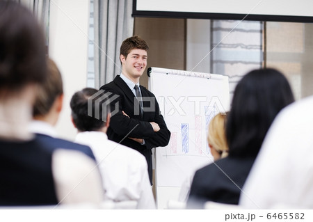 Young business man giving a presentation on conference 6465582