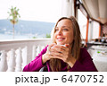Woman in a restaurant is drinking coffee 6470752