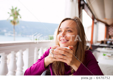 Woman in a restaurant is drinking coffee Woman in a restaurant is drinking coffee 6470752