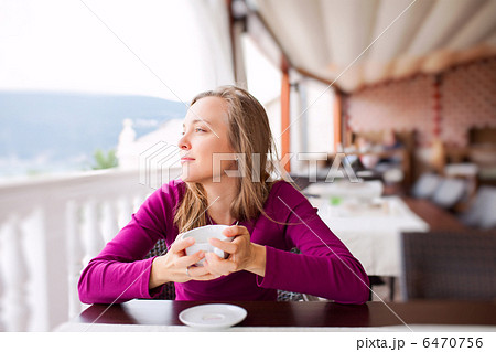 Young Woman at a Cafe Young Woman at a Cafe 6470756