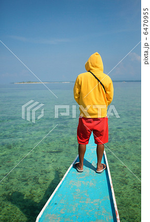 Philippino man on a nose of bangka boat Philippino man on a nose of bangka boat 6470955