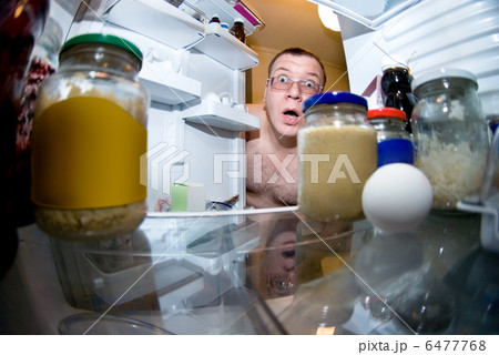 surprised man looks into fridge 6477768