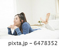 ベットでくつろぐ若い女性 6478352