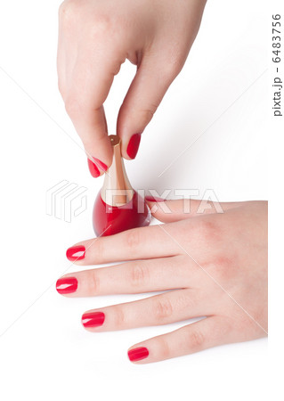 woman applying red nail polish 6483756