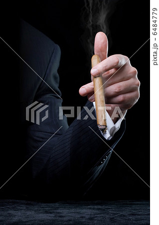 Person holding a cigar Person holding a cigar 6484779