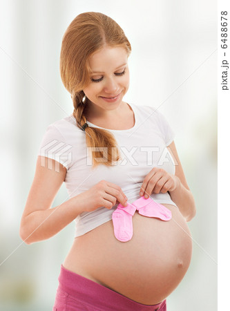 pregnant woman with blue pink baby socks pregnant woman with blue pink baby socks 6488678