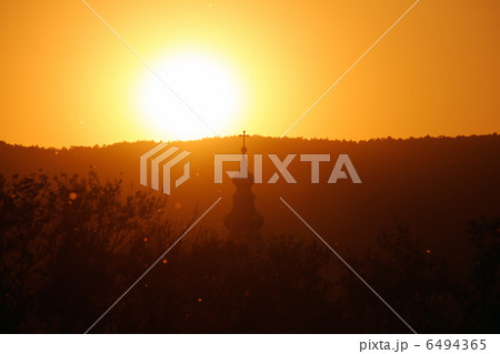 Spring Sunset Over Hills with Old Catholic Church Top in the View 6494365