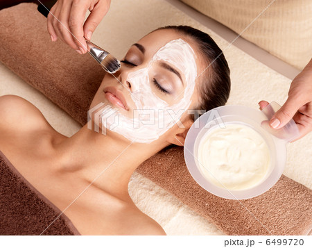 Spa therapy for woman receiving facial mask 6499720