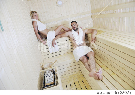 happy young couple in sauna 6502025
