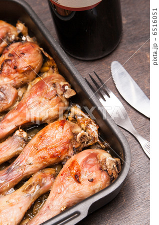baked chicken legs in tray on black wooden 6516051
