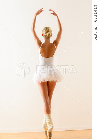 Ballerina pose from behind dancing in studio Ballerina pose from behind dancing in studio 6531418