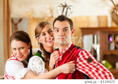 Young people in traditional Bavarian Tracht in restaurant or pub Young people in traditional Bavarian Tracht in restaurant or pub 6539025