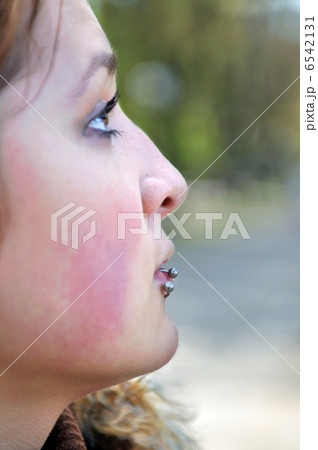 brunette Cute young woman with piercing posing outdoors 6542131