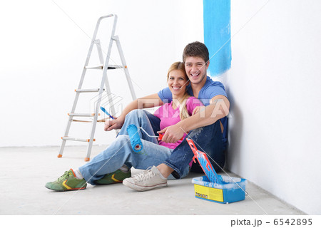 happy young cople relaxing after painting in new home 6542895