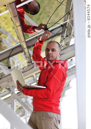 engineer using laptop at solar panels plant field 6544574