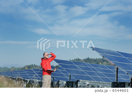engineer using laptop at solar panels plant field engineer using laptop at solar panels plant field 6544601