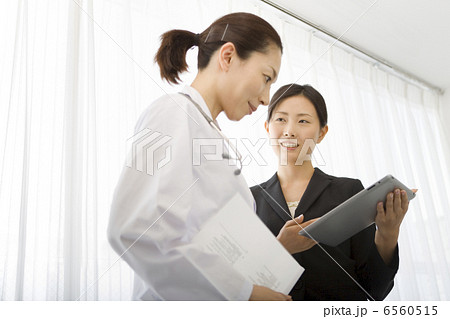 女性医師に資料で説明をする女性MR 6560515