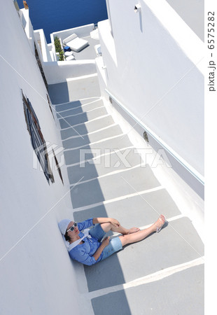 Greek woman on the streets of Oia, Santorini, Greece Greek woman on the streets of Oia, Santorini, Greece 6575282