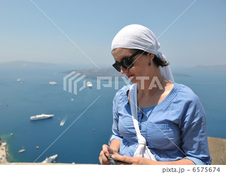 Greek woman on the streets of Oia, Santorini, Greece Greek woman on the streets of Oia, Santorini, Greece 6575674