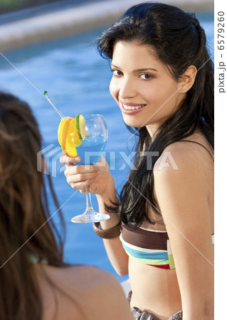 Beautiful Hispanic Latina Woman Drinking A Cocktail With Her Fri 6579260