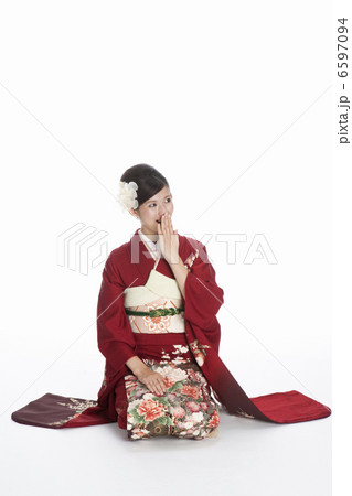 口元に手を当てる振袖姿の若い女性 6597094