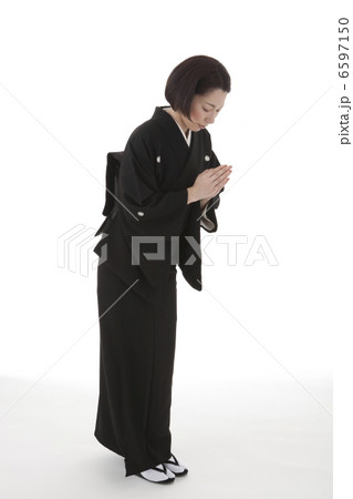 合掌しておじぎをする喪服姿の女性 斜め 合掌しておじぎをする喪服姿の女性 斜め 6597150