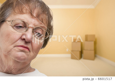 Sad Older Woman In Empty Room with Boxes 6601517