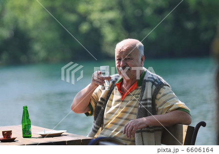 senior man eat desser at outdoor restaurant senior man eat desser at outdoor restaurant 6606164