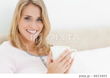 Close up, Woman holding a cup in her hands, while looking ahead Close up, Woman holding a cup in her hands, while looking ahead 6623605