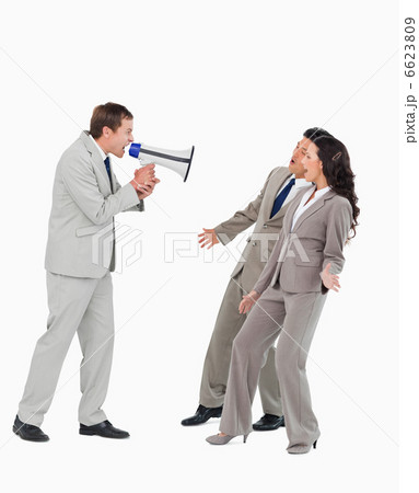 Businessman with megaphone yelling at associates 6623809
