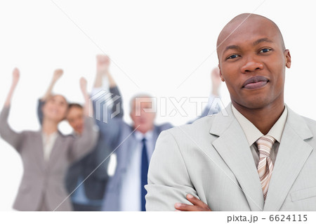 Tradesman with cheering team behind him Tradesman with cheering team behind him 6624115