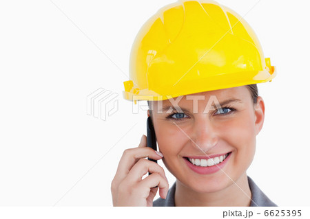 Close up of smiling female architect on her cellphone 6625395