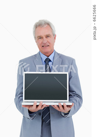 Mature tradesman presenting screen of his laptop Mature tradesman presenting screen of his laptop 6625666
