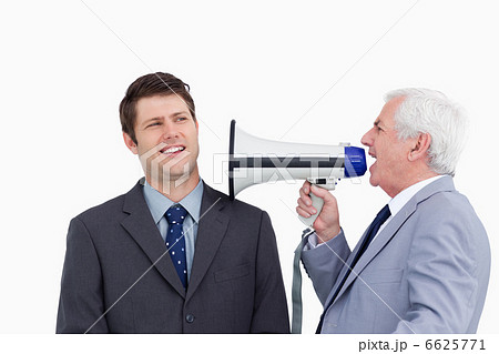 Close up of mature businessman with megaphone yelling at employe Close up of mature businessman with megaphone yelling at employe 6625771