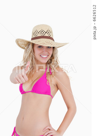 Thin teenager in beachwear showing her thumbs up 6626512