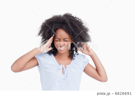 Young woman touching her temples while being angry 6626691
