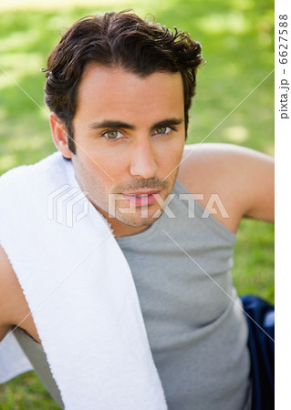 Man looking upwards with a towel resting on his shoulder Man looking upwards with a towel resting on his shoulder 6627588